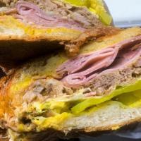 The Cubano · Homemade pernil (pulled pork), Ham, Swiss, Pickles, Yellow Mustard. Served on a toasted garl...