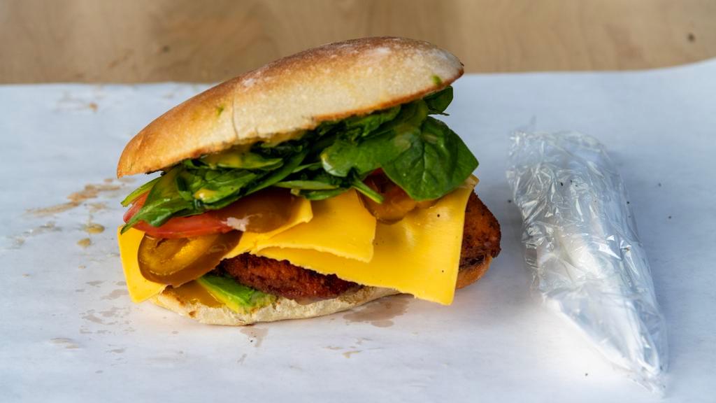 Crispy Chicken Cutlet With American Cheese Sandwich · Ripe avocado, hot cherry peppers, tomato, leafy lettuce, and honey Dijon mustard.
