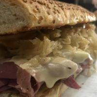 Toasted Reuben Sandwich · First cut corned beef, sauerkraut, sliced pickle chips, swiss cheese and creamy Russian dres...