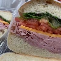 Deluxe Boiled Ham Sandwich · American cheese, shredded lettuce, tomato, mayo, oil, and vinegar.