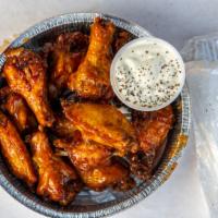 Buffalo Tossed Chicken Wings · Crispy chicken wings tossed in buffalo sauce (half dozen or dozen).