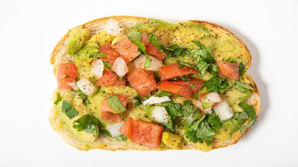 Avocado Toast · Toasted challah bread with smashed avocado and tomato.