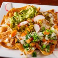 Nachos · Fresh homemade chips with refried pinto beans. Served with pico de gallo, guacamole, melted ...