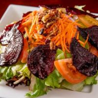 Ensalada Milear · Mixed green lettuce, beets, onions, and carrots with sprinkles of roasted pecans mixed with ...
