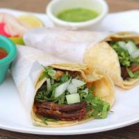 Lengua · Beef tongue. Served with onions and chopped cilantro.