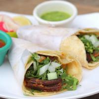 Buche · Grilled steak. Served with onions and chopped cilantro.