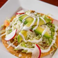 Tostadas · Flat crispy tortilla layered with refried beans, melted cheese, lettuce, tomatoes, sour crea...
