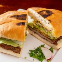Tortas · Mexican sandwich with a spread of beans, tomatoes, lettuce, onions, mayonnaise, jalapeños, f...