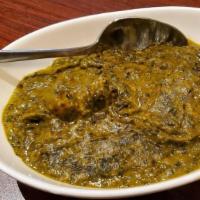 Chicken Palak · Braised chicken in herb and spiced spinach sauce.