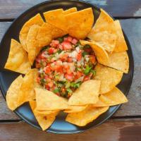 Pico De Gallo W/ Chips · Thin & crispy corn chips served with our home-made Pico De Gallo.