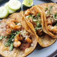 Shrimp Tacos (3) · Grilled shrimp marinated with spicy garlic sauce, grilled to perfection and placed in a warm...