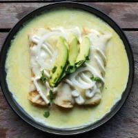 Enchiladas Suizas · Grilled chicken gently placed into warm corn tortillas, bathed with creamy green sauce and t...