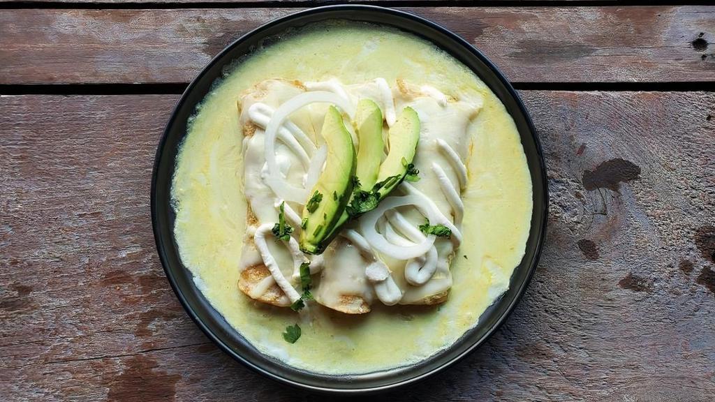 Enchiladas Suizas · Grilled chicken gently placed into warm corn tortillas, bathed with creamy green sauce and topped with melted mozzarella cheese, sour cream, onion, and avocado slices. (Adult Size)