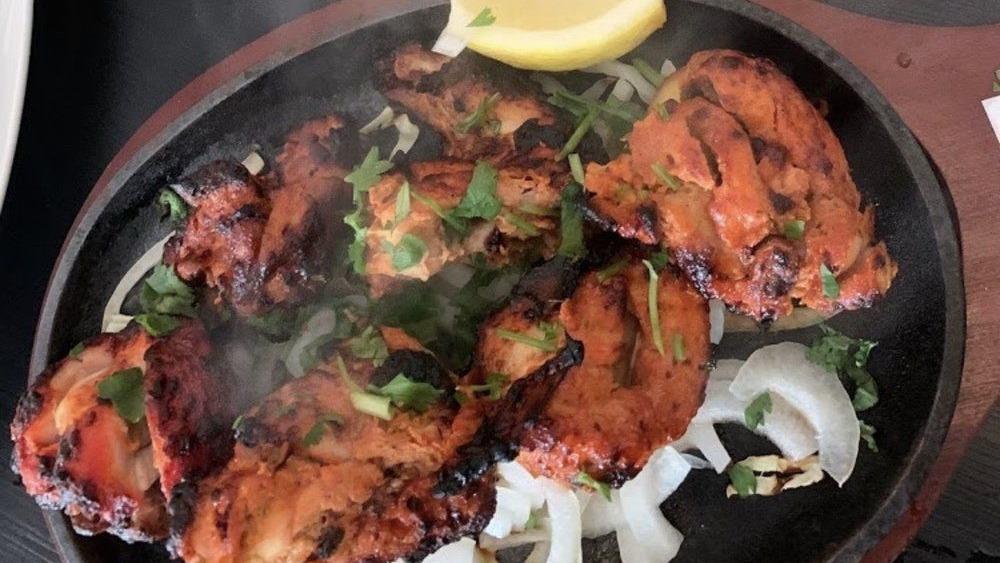Chicken Bihari Boti · Boneless chicken cubes marinated with aromatic spices and slowly cooked to perfection on charcoal. Gives a delicious smokey flavor.