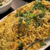 Chicken Biryani · Basmati rice cooked in a special blend of chicken, spices and herbs.