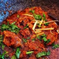 Goat Karahi · A Peshawari style stirs fry chicken with plump tomato curry, spiced with black pepper and ga...
