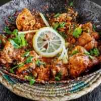 Chicken Karahi · Popular Lahori style curry with ripen tomatoey base, stir-fried in karahi with spices, finis...