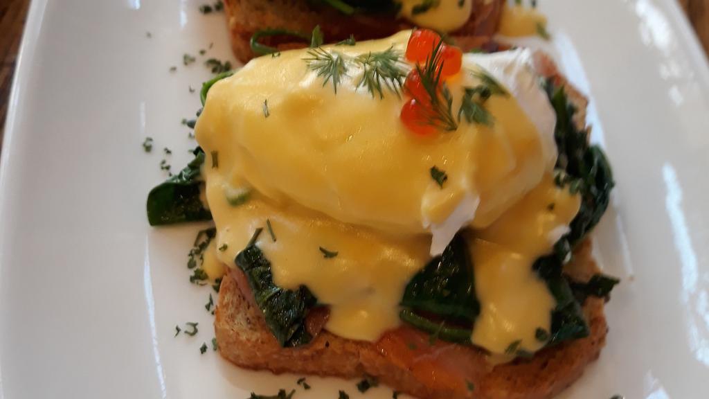 Eggs Benedict · A savory combination of  spinach, smoked lox, a runny egg and hollandaise sauce.
