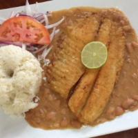 Pescado Frito With Arroz, Frijoles Y Salsa Criolla · Fried tilapia with rice, beans, and criolla sauce.