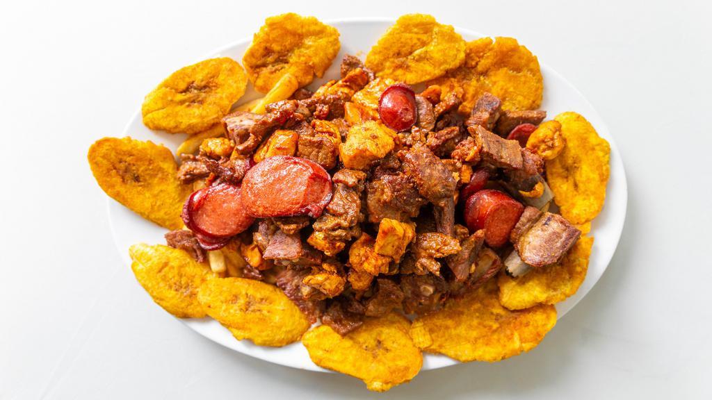 Picada Grande / Large Fritters · Con papas fritas, tostones, cerdo asado, res, pollo y salchicha / Served with french fries, green plantains, fried pork, beef, chicken & sausage
