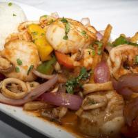 Camarones Saltados · Shrimp sautéed with onions, and tomatoes, with fries and white rice.