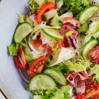 Garden Salad · Delicious salad combining lettuce, tomatoes, carrots, and cucumbers, drizzled with salad dre...