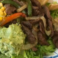 Steak Ranchero Salad · Romaine lettuce, sliced steak, sauteed onions, and peppers, corn salsa, chips, and guacamole...