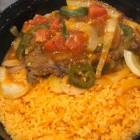 Bistec A La Mexicana · Grilled steak with onions, tomatoes, and spices. Served with rice, refried beans, flour tort...