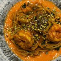 Spaghetti Alla Chitarra · with Prawns, Fresh Tomato Cream, Bisque Sauce, Baby Spinach and Chopped Pistachios