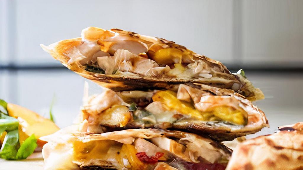Chicken Quesadilla · Grilled chicken, bell peppers, onions, Cheddar, and Pepper Jack. Includes sour cream, guacamole, and pico de gallo on the side.