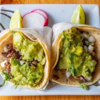 Tacos · Corn tortilla with choice of meat, cilantro, onions and guacamole.