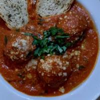 Meatballs · Homemade meatballs topped with Parmigiano Reggiano, tomato sauce, basil & toasted bread.