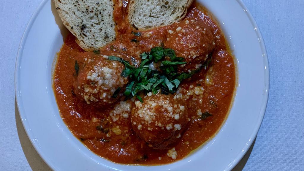 Meatballs · Homemade meatballs topped with Parmigiano Reggiano, tomato sauce, basil & toasted bread.