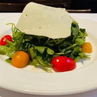 Arugula E Parmigiano · Baby arugula, cherry tomatoes, Parmigiano & fig vinaigrette.