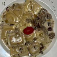 Ravioli Al Porcini · Ricotta & porcini ravioli sauteed with porcini mushrooms.