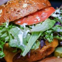 Grass Fed Kobe Beef Burger · Our fresh Kobe beef burger topped with mesclun greens, tomato, cheddar cheese and our specia...