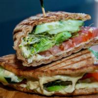 Vegetarian Pita Sandwich · Homemade hummus, cucumber, sliced tomato, avocado and sprouts served on a whole wheat flatbr...