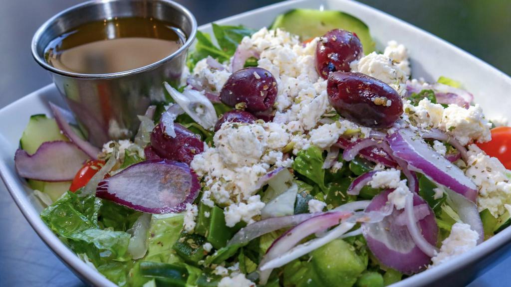Greek Salad · Romaine lettuce, grape tomatoes, onions, cucumbers, olives, feta cheese, green peppers topped with house vinaigrette. Also available with chicken for an additional charge.
