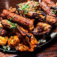 Mixed Grill Sizzler · Chicken seekh kabab, Malai kabab, tandoori leg, chicken tikka boti, beef bihari kabab  mixed...