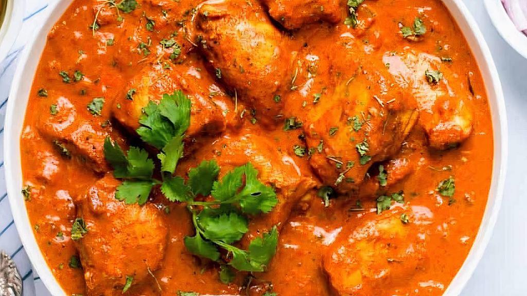 Chicken Tikka Masala · Chicken tikka cooked in a clay oven then cooked to a curry using thick fresh onions, peppers, and tomato.