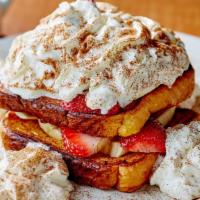 French Toast Napoleon · Layers of French toast filled with strawberries, bananas & whipped cream, dusted with powder...