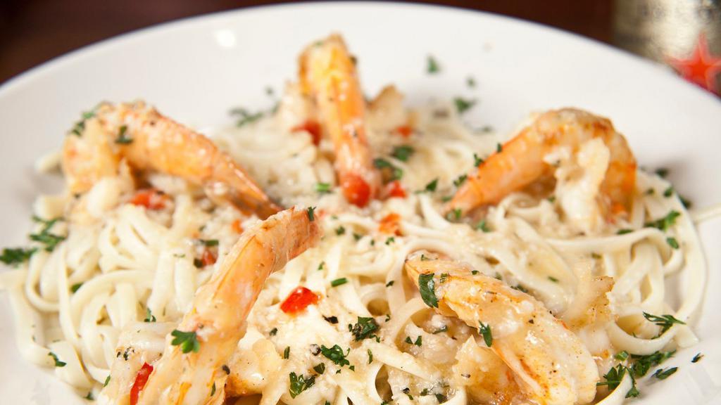 Shrimp Scampi · Jumbo shrimp sauteed with garlic in a butter & white wine sauce, served over linguine or rice.