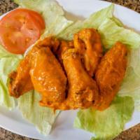 Buffalo Chicken Wings · Baked and deep-fried crispy chicken wings in a fiery buffalo sauce.