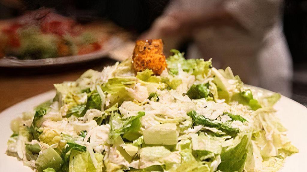 Caesar Salad · Romaine Lettuce Tossed In Homemade Caesar Dressing Topped With Pecorino Romano And Crumbled Croutons