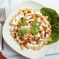 Chat Papari · Diced potatoes, chickpeas and onions served with puffed wheat wafers and garnished with yogu...