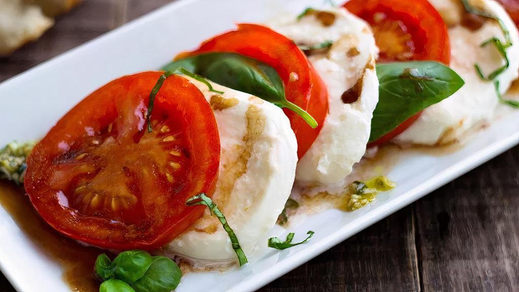 Mozzarella Caprese · Sliced Fresh Mozzarella, Sliced Plum Tomatoes, Kalamata Olives & Fresh Basil topped with Balsamic Glaze.