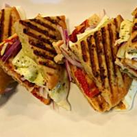 Grilled Chicken Panini · Grilled Chicken with melted Fresh Mozzarella, Sun dried Tomatoes, Red Onion & Creamy Pesto i...
