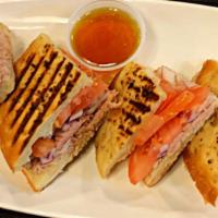 Italian Tuna Panini · Italian Tuna with Red Onions & Tomatoes in our Homemade Panini Bread. Served with a side of ...