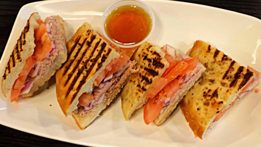 Italian Tuna Panini · Italian Tuna with Red Onions & Tomatoes in our Homemade Panini Bread. Served with a side of Extra Virgin Olive Oil.
