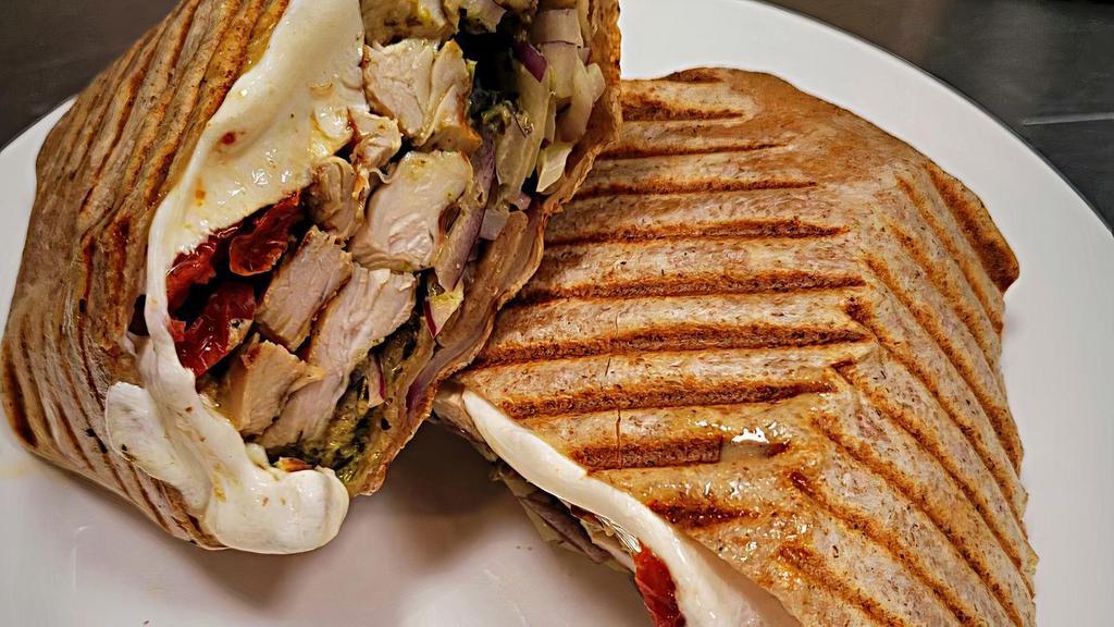 Grilled Chicken Whole Wheat Wrap · Grilled Chicken with melted Fresh Mozzarella, Sun dried Tomatoes, Red Onion & Creamy Pesto in a whole wheat wrap.